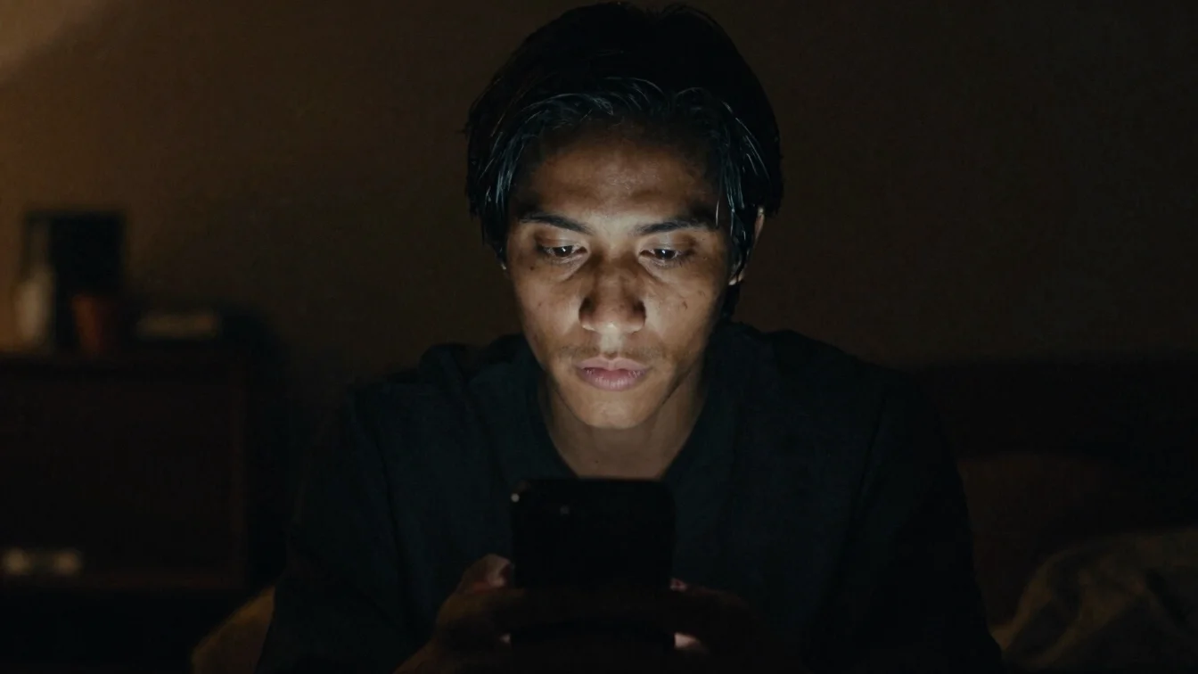 Native vertical frame, low-key close shot of a performer's face l