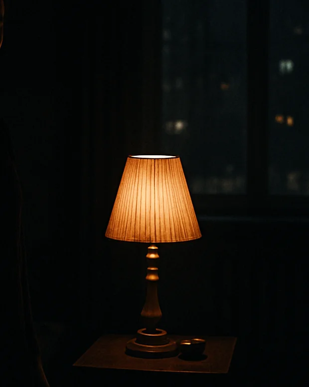 Wide anamorphic film still, low-key lighting in a charcoal-black